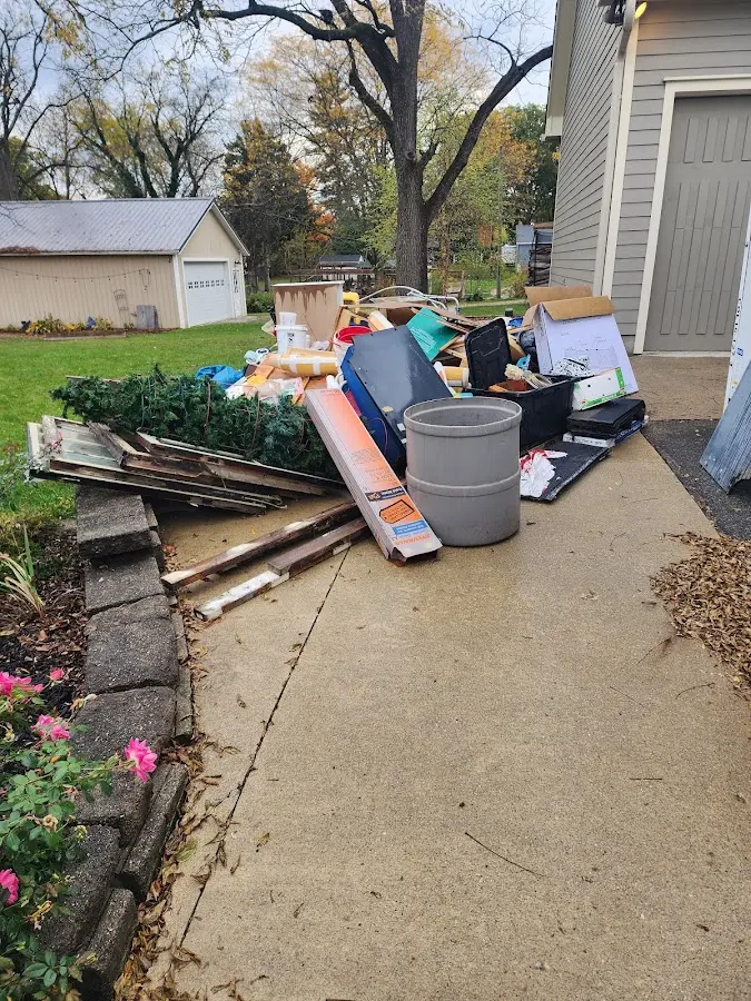 Dumpster being loaded with debris for Estate Cleanout Dumpster Rental in Windsor